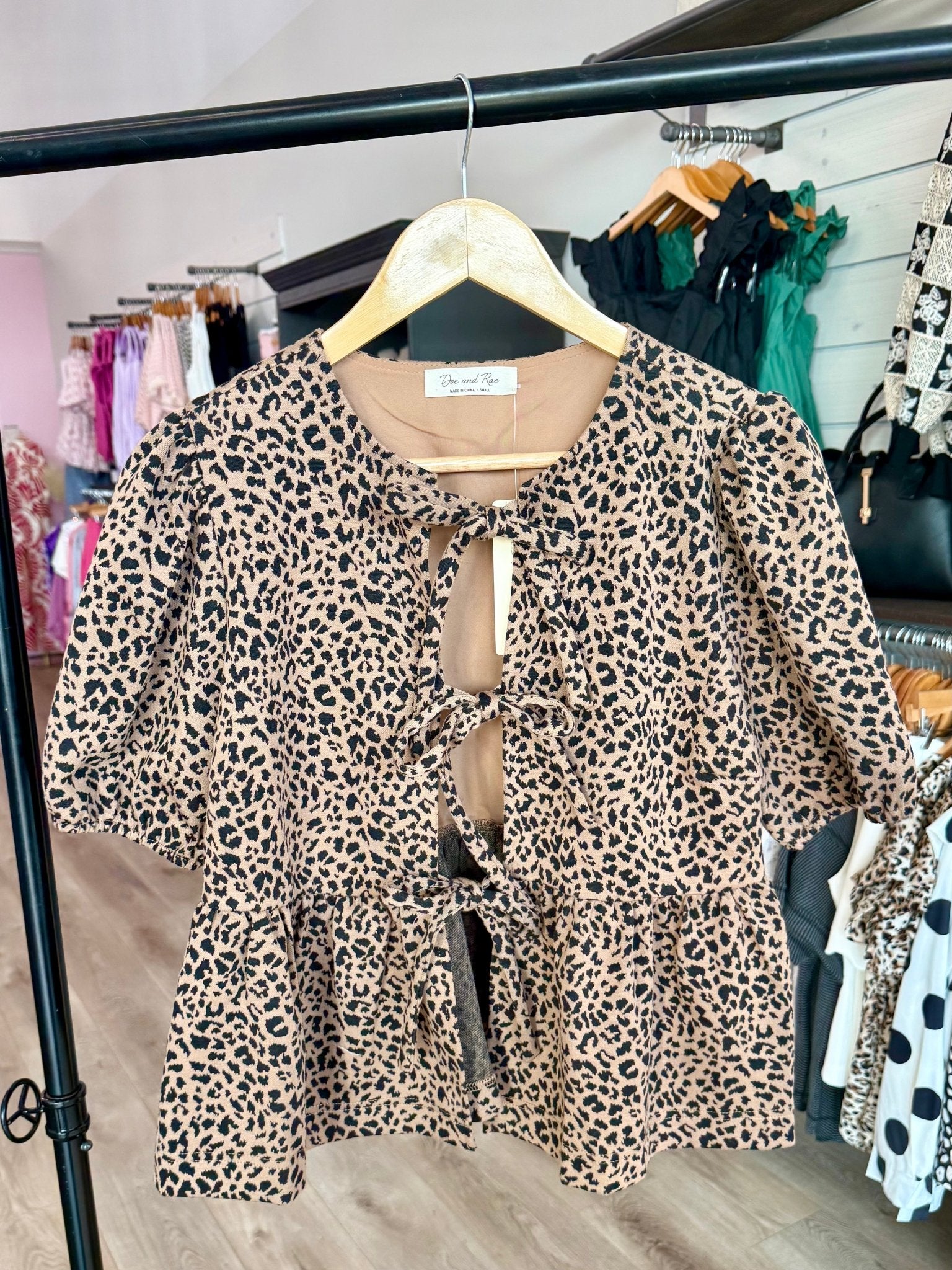 COTTON ANIMAL PRINT PUFF SHORT SLEEVE BOW TIE FRONT PEPLUM - Mainstream Boutique