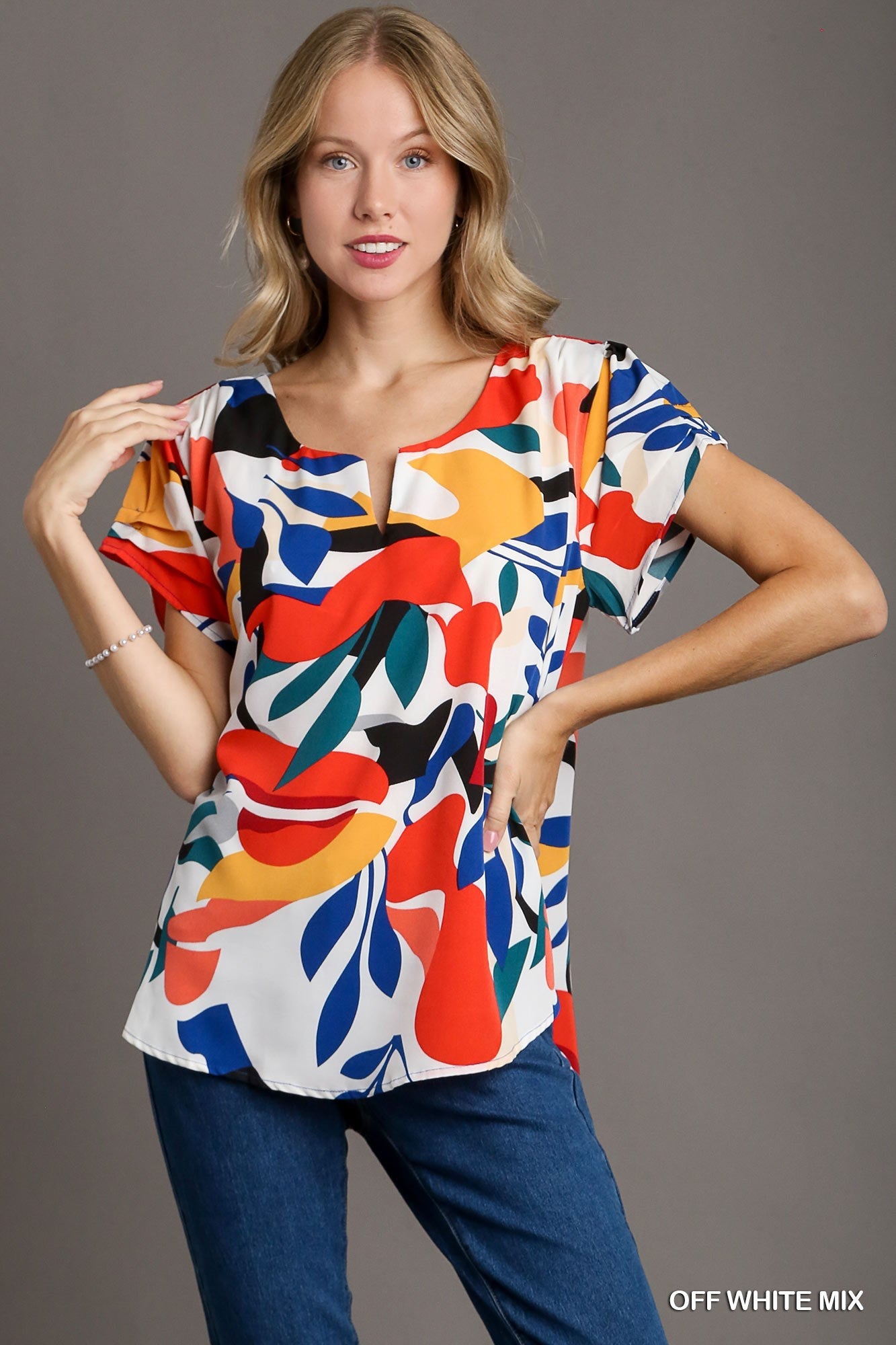 Short Sleeved Abstract Print Top Featuring A Split Neckline And Rounded High Low Hemline - Mainstream Boutique