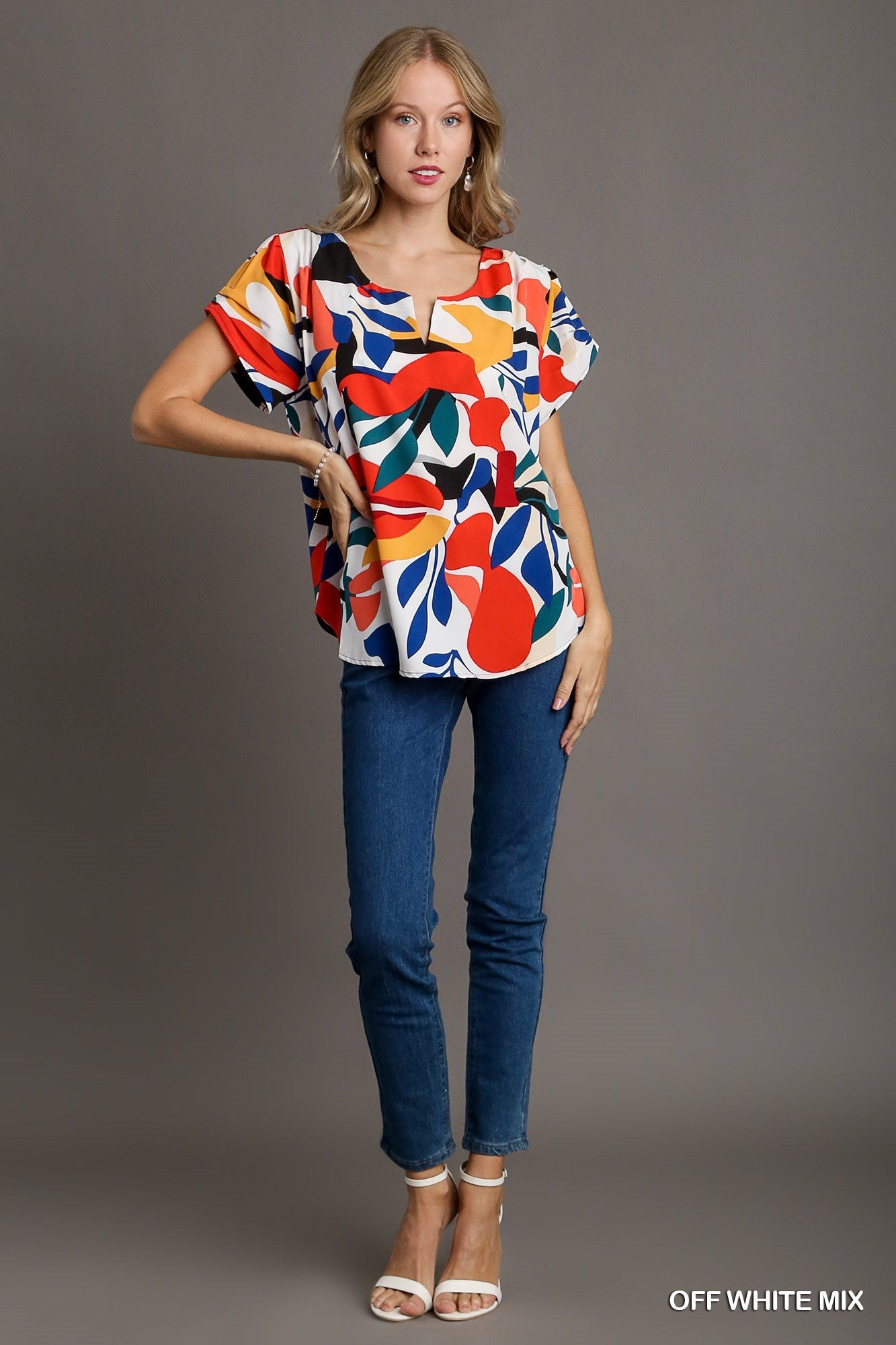 Short Sleeved Abstract Print Top Featuring A Split Neckline And Rounded High Low Hemline - Mainstream Boutique