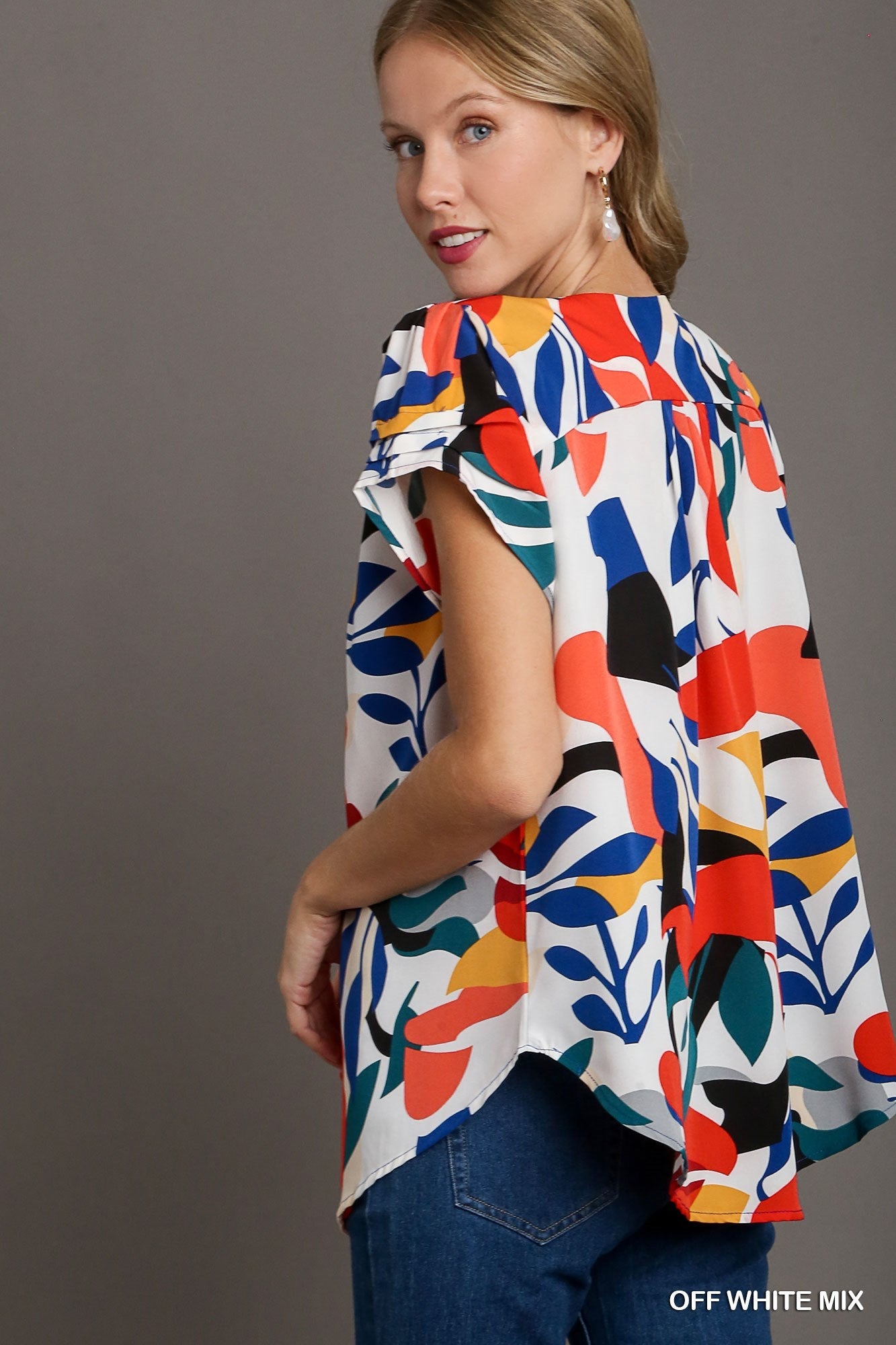 Short Sleeved Abstract Print Top Featuring A Split Neckline And Rounded High Low Hemline - Mainstream Boutique