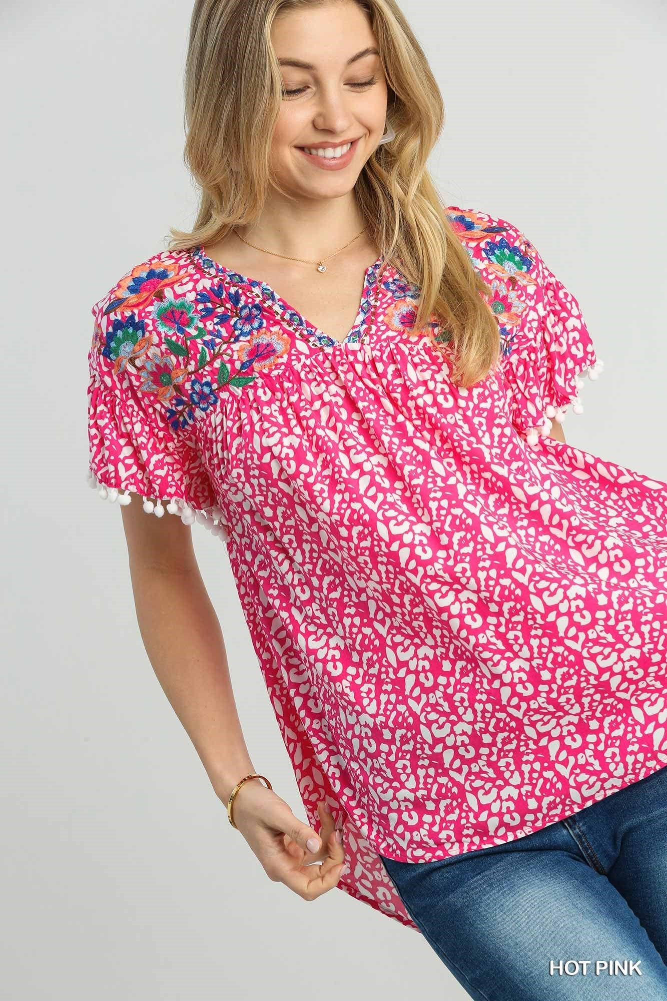 Animal Print Split Neck Ruffle Sleeve Top With Pom Pom Fringe Detail & Flower Embroidery - Mainstream Boutique