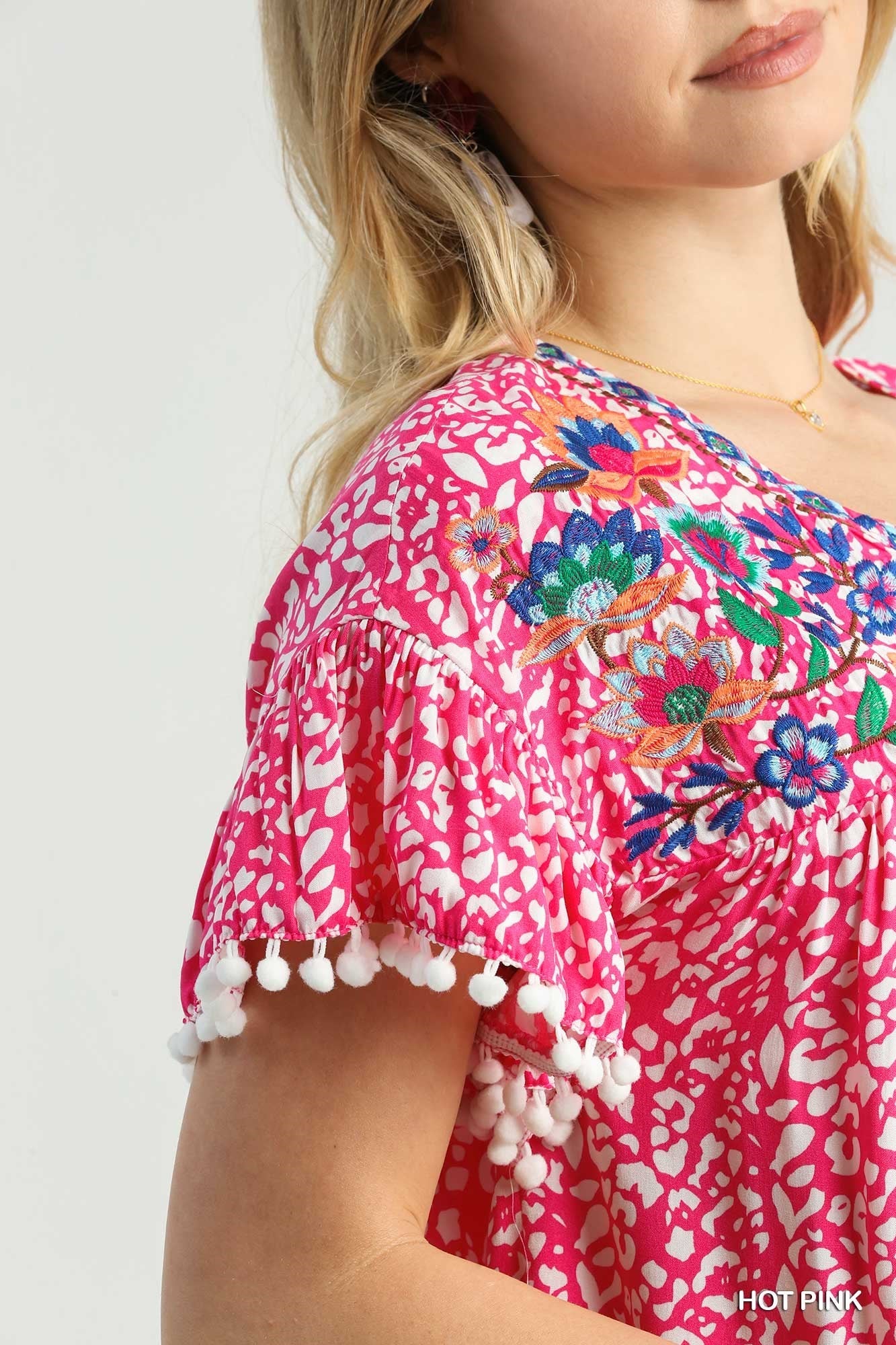 Animal Print Split Neck Ruffle Sleeve Top With Pom Pom Fringe Detail & Flower Embroidery - Mainstream Boutique