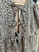 COTTON ANIMAL PRINT PUFF SHORT SLEEVE BOW TIE FRONT PEPLUM - Mainstream Boutique
