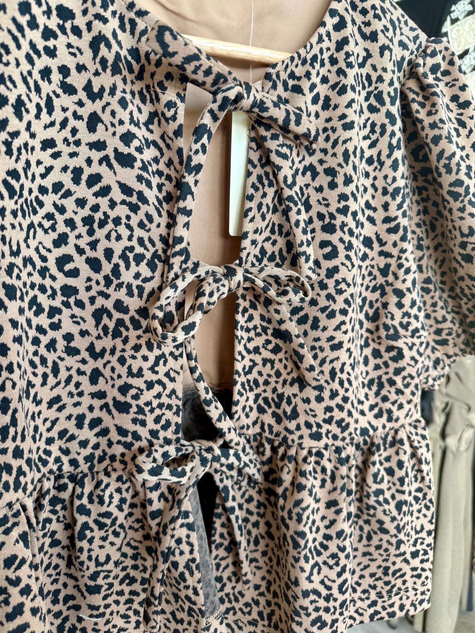 COTTON ANIMAL PRINT PUFF SHORT SLEEVE BOW TIE FRONT PEPLUM - Mainstream Boutique