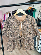 COTTON ANIMAL PRINT PUFF SHORT SLEEVE BOW TIE FRONT PEPLUM - Mainstream Boutique