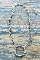 Gretchen necklace is a silver necklace with a silver ring pendant.