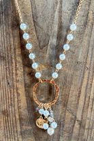 Necklace with circular pendant and beads on a wooden surface