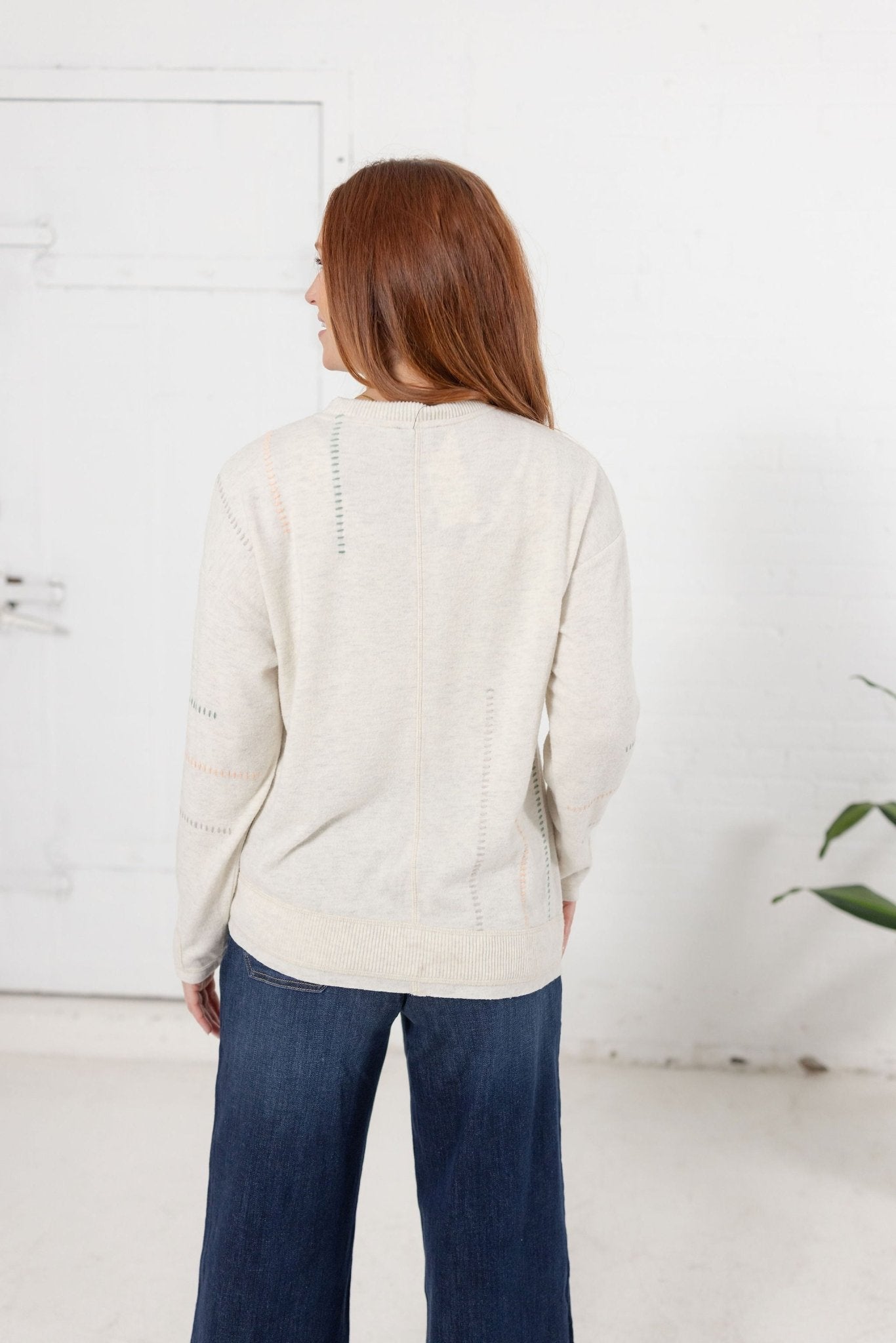 Long Sleeve Top With Embroidery Detail And Asymmetrical Hem - Mainstream Boutique