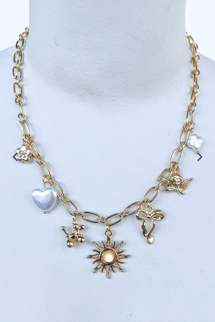 Gold necklace with various charms on link chain.