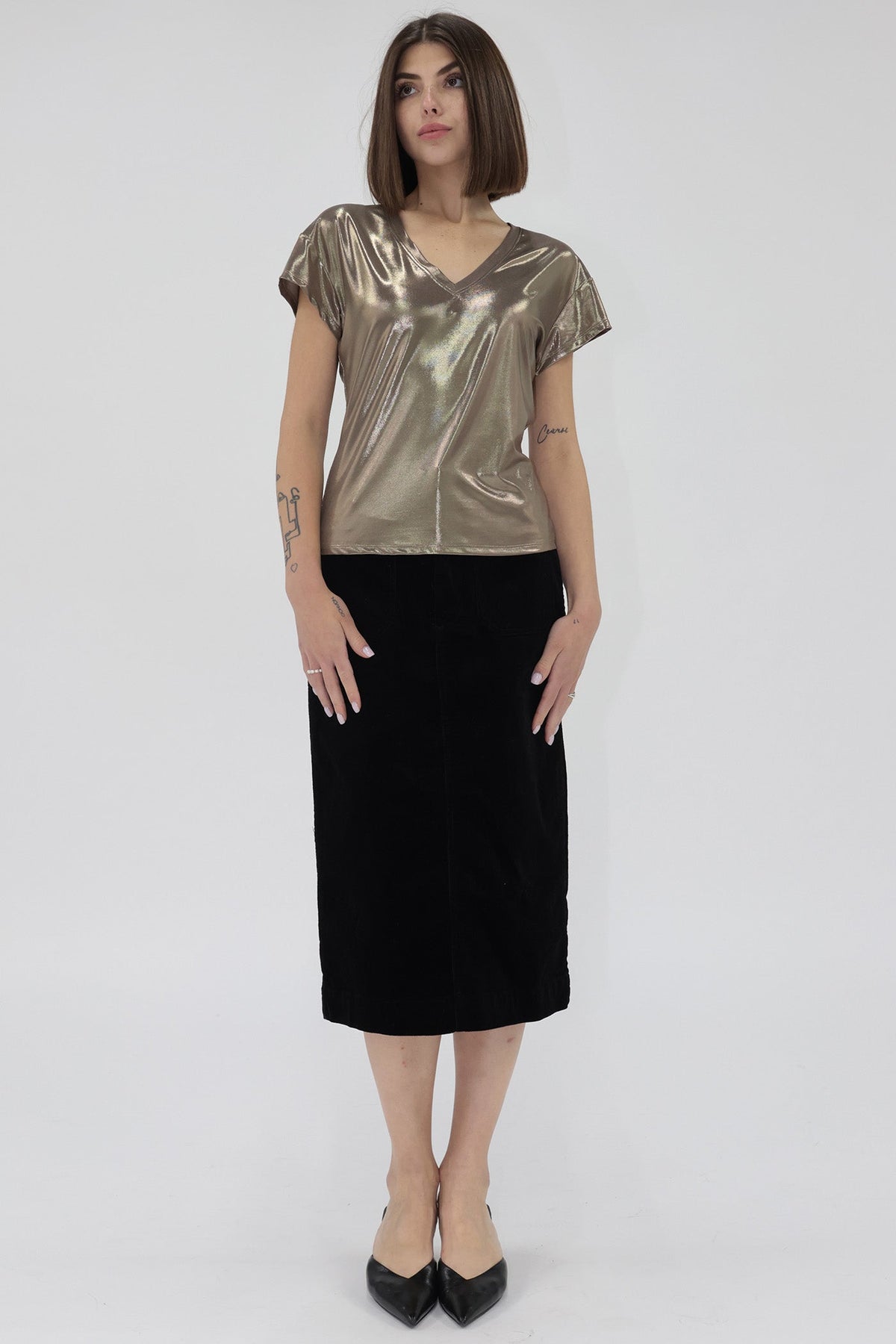 Woman wearing a metallic gold top 
