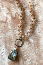 crystal necklace with a gunmetal ring and a crystal pendant.