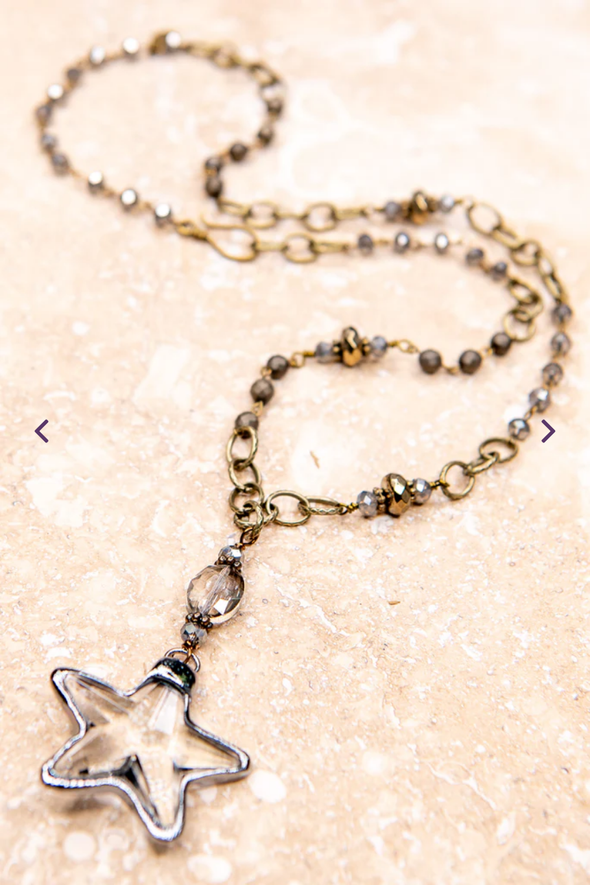Star pendant on a gold chain adorned with beads and crystals.